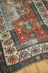 Lower corner detail of antique Caucasian Kazak runner, showcasing its geometric pattern and worn texture.