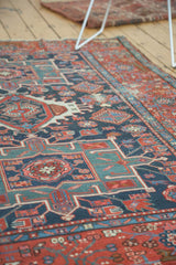 Antique Karaja rug with geometric floral motifs in navy, mallard green, and coral red.