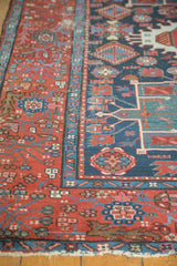 Karaja rug's stylized geometric floral motifs and visible foundation in navy blue and red.