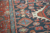 Antique Karaja rug's navy, red, and ivory geometric patterns, showing pile wear and foundation.
