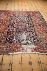 Localized wear on vintage Karaja rug, foundation visible, navy and red geometric patterns.