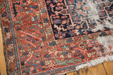 Karaja rug corner detail: madder red field, navy border, worn pile, exposed foundation.