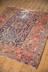 Vintage Karaja rug's madder root red border, rectilinear floral patterns, and localized wear.