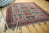 Antique square Afshar rug displaying its allover bird design and texture in a naturally lit room.