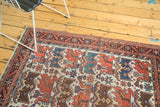 Antique Afshar rug's detailed tribal patterns and wool texture in a lifestyle view.