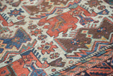 Close view of the low pile and repeating bird motif on a hand-knotted antique Afshar rug.