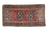 Antique Persian Heriz runner, double octagonal medallions in madder red, navy, and teal.