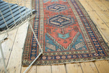 Secure overcasting, madder red field, and navy geometric border of antique Heriz runner.