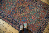 Vintage Karaja rug displaying geometric medallion, intricate weave, madder red, navy blue.