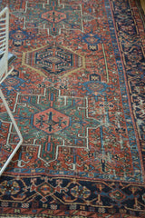 Intricate geometric Karaja rug pattern with elongated vinery in madder red and navy blue.
