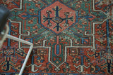 Hand-knotted Karaja rug, showcasing intricate geometric patterns in madder red and teal.