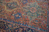 Karaja rug's intricate weave and stylized vinery with red, blue, gold floral motifs.