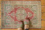 Antique Kaisary rug with Oushak-style medallion, time-softened tones, and visible wear.