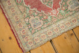 Antique Silk Kaisary rug border: mint green, ivory, blush trefoil pattern, and visible foundation wear.