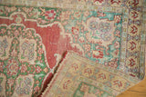 Folded corner of antique Kaisary rug, revealing hand-knotted back and wear.