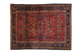 Vintage Persian Lilihan rug: cochineal red field, medallion, sprawling palmettes, navy borders.