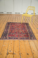 Vintage Lilihan rug's cochineal red field, sprawling palmettes, tendrils, and dark navy border.