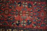 Vintage Lilihan runner pile with recessed raspberry field, navy, and teal floral motifs.
