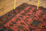 Lilihan rug corner close-up with dark blush field, ornate paneled tree of life, and sky blue outlines.