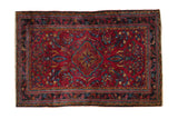 Raspberry red vintage Lilihan rug, dark navy scalloped medallion, golden floral tendrils, 3'4