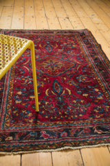 Vintage Lilihan rug's raspberry red field, detailed palmettes, sprawling tendrils, and fringe.