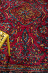 Sprawling palmettes and tendrils in deep navy, dusty gold, and sky blue on a vintage Lilihan rug.