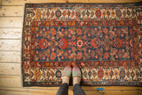 Vintage Malayer rug with navy blue Herati field and red, orange, ivory patterned border.