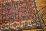 Vintage Persian Malayer rug corner, navy Herati field, multi-color borders, bound edge.