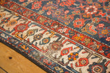 Colorful patterned border of the vintage Malayer rug, with visible machine binding.