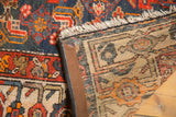 Detailed view of Malayer rug's woven foundation and brown machine-bound selvage.