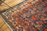 Intricate Herati motifs on the ivory border and deep navy field of a vintage Malayer rug.
