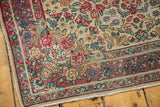 Vintage Kerman rug corner, mil fleur and rose motifs, even pile wear, tattered edge.