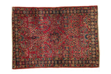 Vintage Persian Lilihan rug, cherry red field with Sarouk floral design in blue and gold, gentle central wear.