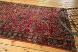 Close-up of vintage Lilihan rug, intricate floral motifs, and localized wear on cherry red field.