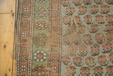Visible threadbare wool pile and intricate mir boteh pattern on distressed antique Kurdish fragment.