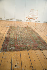 Distressed Antique Kurdish rug fragment, showing allover mir boteh design with worn pile and soft hues.