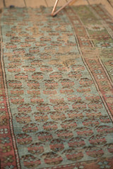 Close-up of distressed antique Kurdish fragment: pale blue mir boteh design and significant wear.