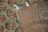 Distressed antique Kurdish rug fragment reveals wool-on-wool weave, exposed foundation, muted hues.