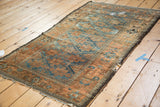 Distressed sapphire blue and terra cotta geometric pattern with tattered edges.