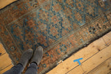Distressed sapphire blue field and terra cotta border with geometric guls on this antique Belouch rug.
