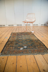 Storied repair on the sapphire blue field of this distressed antique Belouch rug.