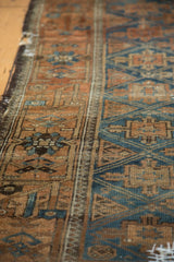 Distressed Belouch rug border and field transition, sapphire blue and copper geometric motifs.