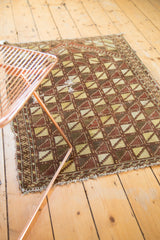 Geometric lattice pattern on a hand knotted Belouch rug, highlighting light darning and overcast blanket stitch.