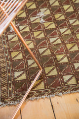Chestnut brown, saffron yellow geometric pattern detail with visible repair and overcast blanket stitch.