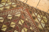 Geometric lattice pattern in saffron, brown, and ivory with overcast edge stitching.
