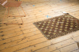 Antique Belouch rug's full geometric lattice design with saffron, brown, and ivory tones.