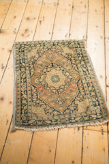 Left edge of the antique Jalili Tabriz mat, featuring secured fabric banding and fine floral patterns.