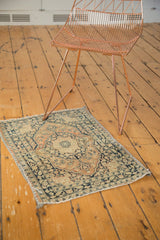 Antique Jalili Tabriz rug corner detail: banded edge with charcoal and dusty rust patterns.