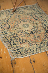 Antique Persian Jalili Tabriz rug corner with fabric-banded edge and intricate pattern.