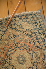 Intricately woven dusty rust and charcoal 'book cover' spandrel of antique Tabriz rug.